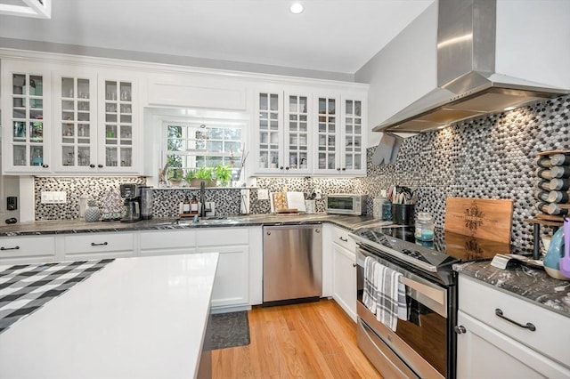 6 Edgehill Rd, Billerica, MA 01862 - kitchen with range hood, appliances with stainless steel finishes, decorative backsplash, light wood-style flooring, and white cabinetry
