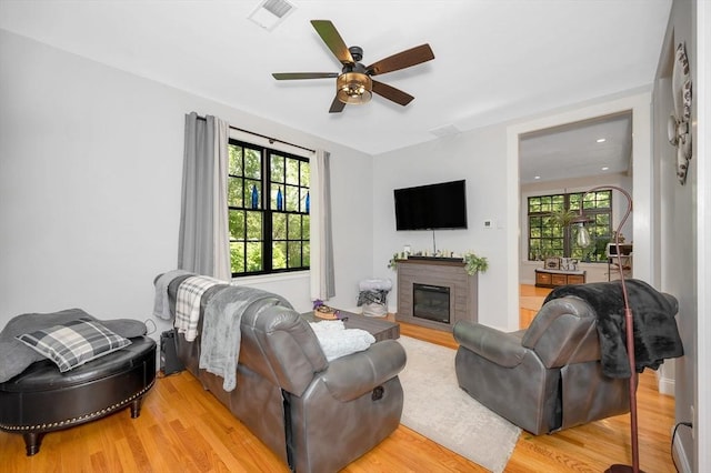 6 Edgehill Rd, Billerica, MA 01862 - living room featuring a ceiling fan, light wood-type flooring, and a glass covered fireplace