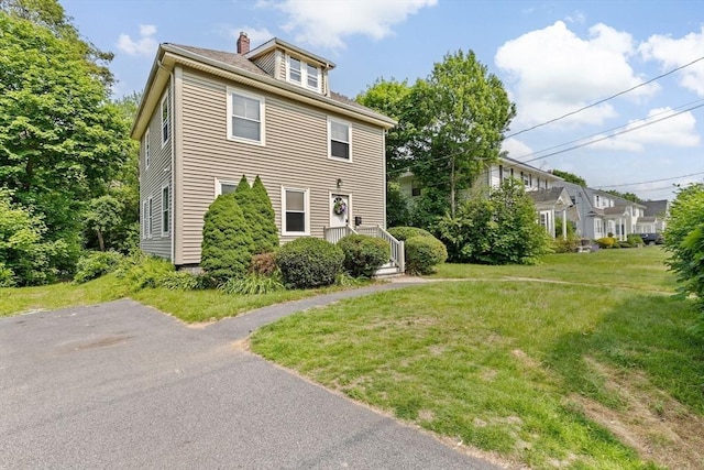 181 Myrtle St, Rockland, MA 02370 - view of front of house featuring a chimney and a front yard