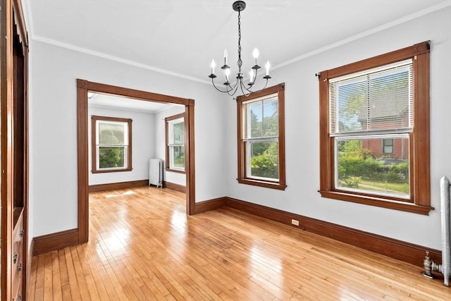 181 Myrtle St, Rockland, MA 02370 - spare room with radiator heating unit, baseboards, a chandelier, ornamental molding, and light wood-style floors
