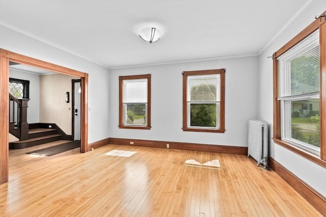 181 Myrtle St, Rockland, MA 02370 - spare room with radiator, baseboards, light wood-type flooring, crown molding, and stairway