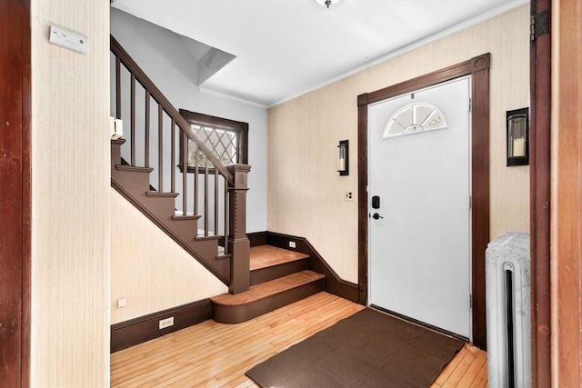 181 Myrtle St, Rockland, MA 02370 - entrance foyer with wood-type flooring, radiator, stairs, and crown molding
