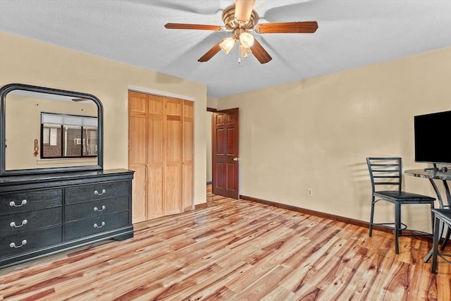 262 E Haverhill St Unit 17, Lawrence, MA 01841 - unfurnished bedroom featuring light wood-style floors, baseboards, a closet, and ceiling fan
