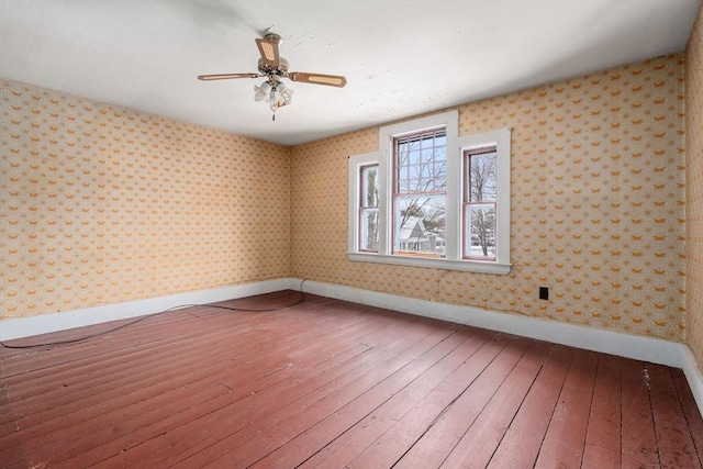 empty room featuring ceiling fan and hardwood / wood-style floors