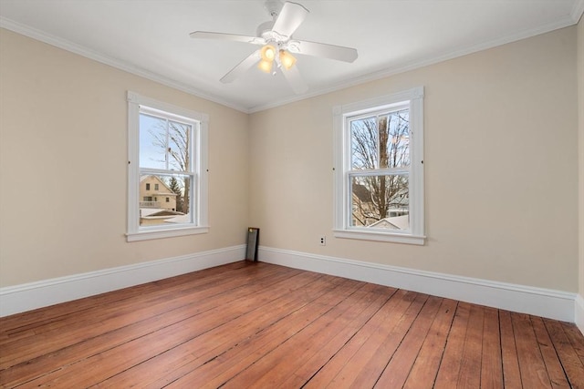 spare room featuring ceiling fan, ornamental molding, and light hardwood / wood-style flooring