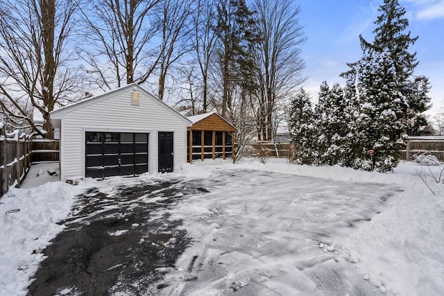 yard layered in snow with a garage