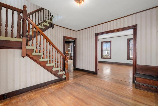 foyer featuring hardwood / wood-style floors and ornamental molding