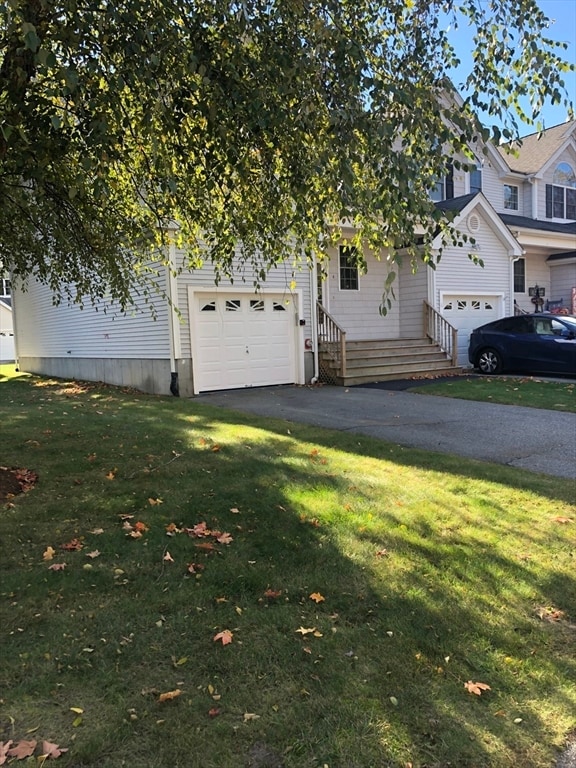 view of front of home featuring a front yard and a garage