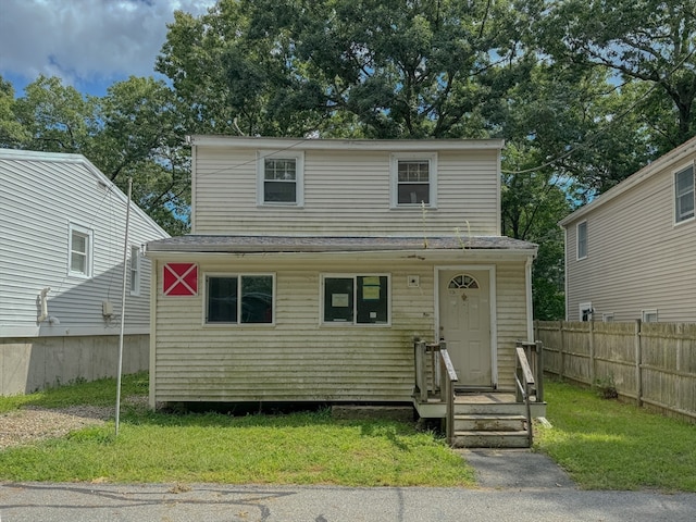 view of property featuring a front lawn