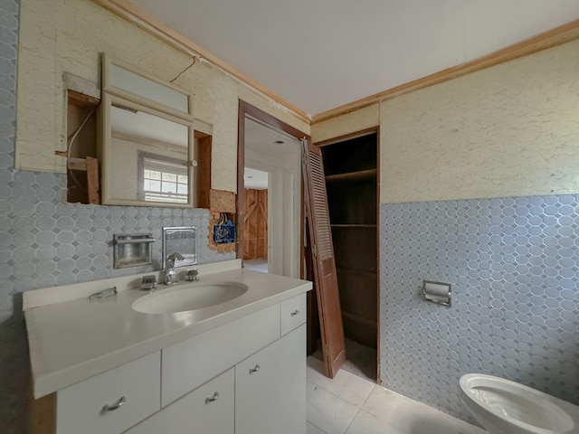 bathroom with tile walls, toilet, and vanity