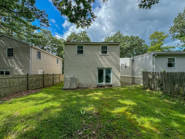 rear view of house with a lawn