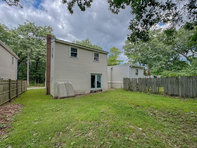 rear view of property with a yard