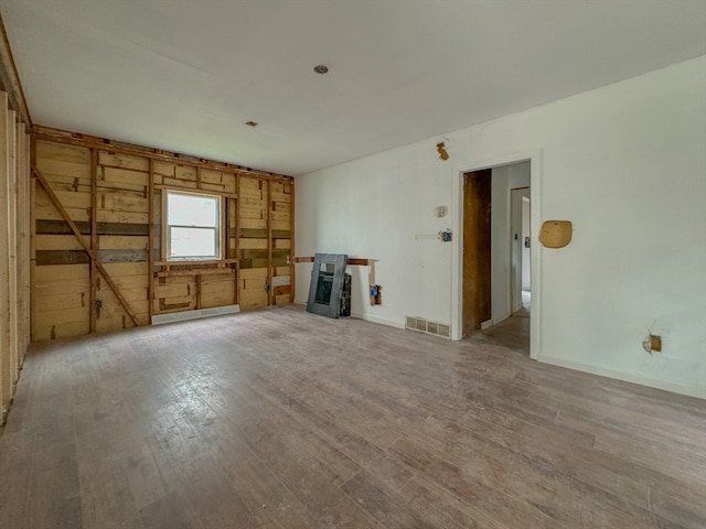 unfurnished living room with wood-type flooring