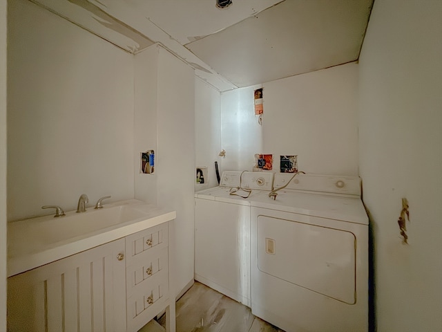 laundry room featuring light hardwood / wood-style flooring, washer and clothes dryer, and sink