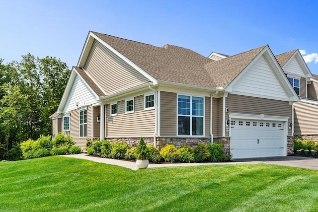 109 Phoebe St Unit 109, Methuen, MA 01844 - view of front of house featuring driveway, a garage, a front yard, roof with shingles, and stone siding