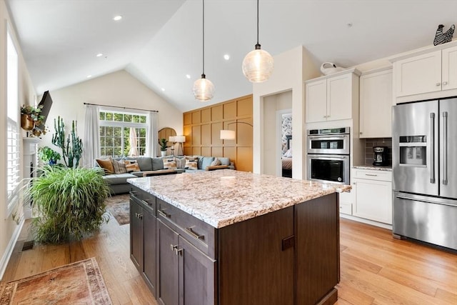109 Phoebe St Unit 109, Methuen, MA 01844 - kitchen with appliances with stainless steel finishes, light wood-style flooring, white cabinetry, and vaulted ceiling