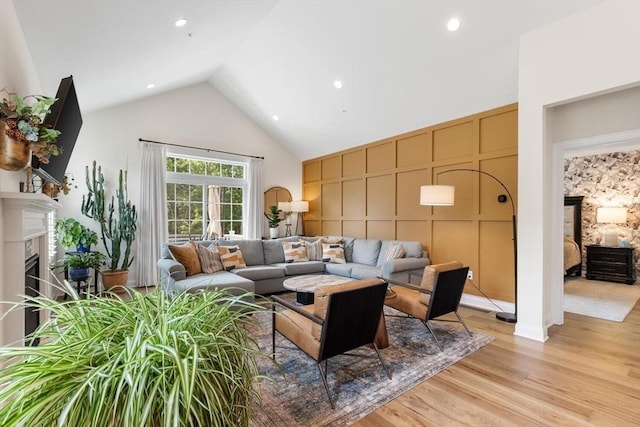 109 Phoebe St Unit 109, Methuen, MA 01844 - living room with high vaulted ceiling, a high end fireplace, light wood finished floors, recessed lighting, and a decorative wall