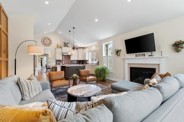 109 Phoebe St Unit 109, Methuen, MA 01844 - living room featuring wood finished floors, a glass covered fireplace, vaulted ceiling, and recessed lighting