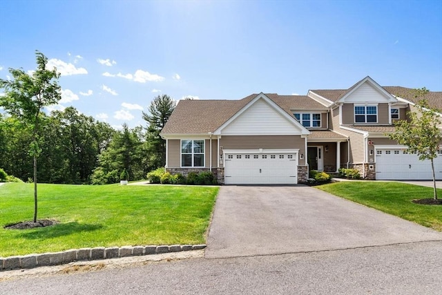 109 Phoebe St Unit 109, Methuen, MA 01844 - view of front facade featuring asphalt driveway, a garage, a front lawn, and stone siding