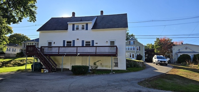 back of property with a wooden deck