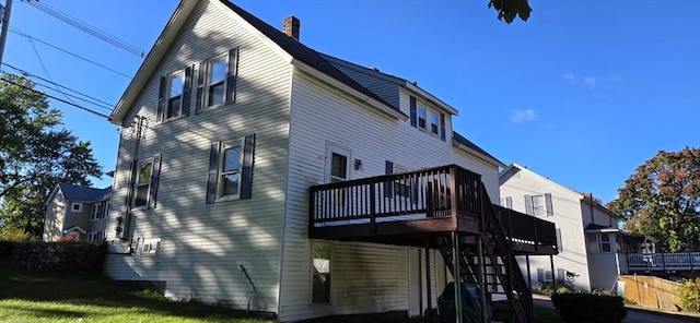 back of house with a wooden deck