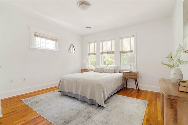 bedroom featuring light wood-type flooring and baseboards