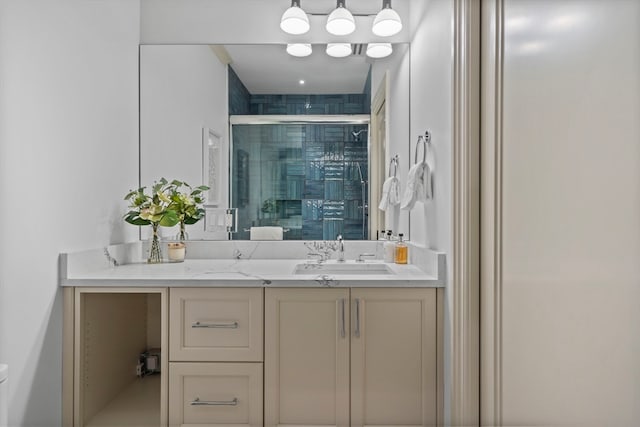 bathroom featuring vanity, toilet, and a shower with shower door