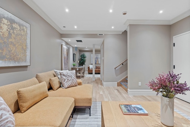 living room featuring light wood-type flooring and ornamental molding