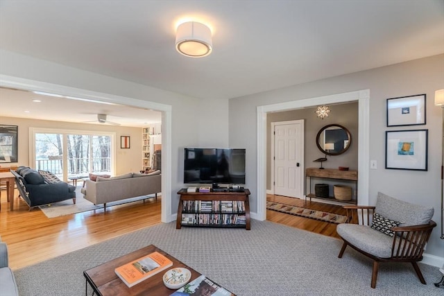 living room featuring baseboards and wood finished floors
