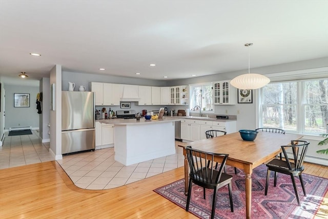 dining space featuring recessed lighting, light wood-style flooring, and a wealth of natural light