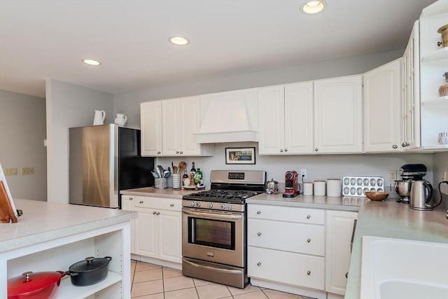 kitchen featuring light countertops, open shelves, appliances with stainless steel finishes, and premium range hood