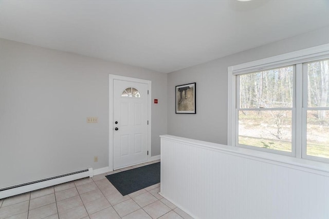 foyer entrance featuring wainscoting, light tile patterned floors, and baseboard heating