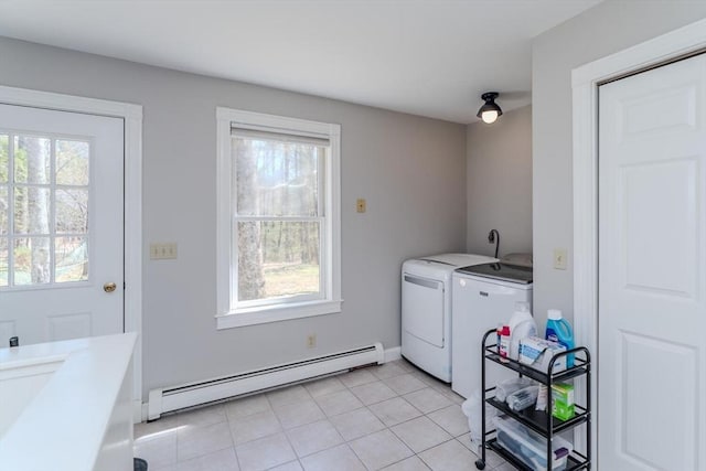 laundry room with plenty of natural light, baseboard heating, independent washer and dryer, and laundry area