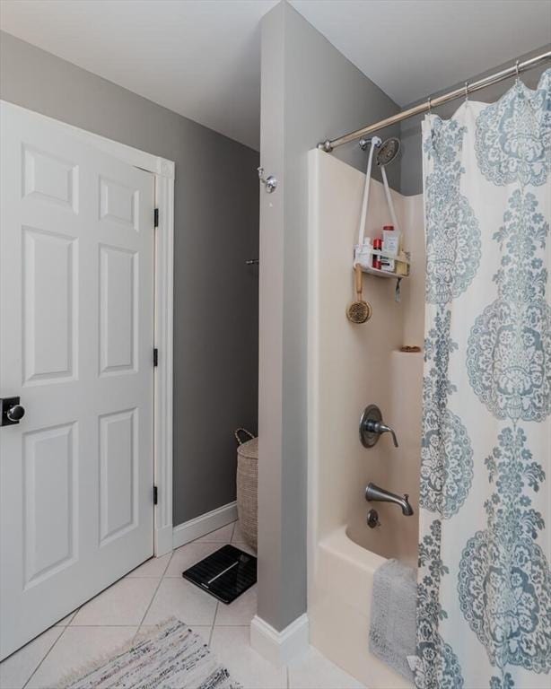 bathroom featuring tile patterned floors, baseboards, and shower / bath combination with curtain