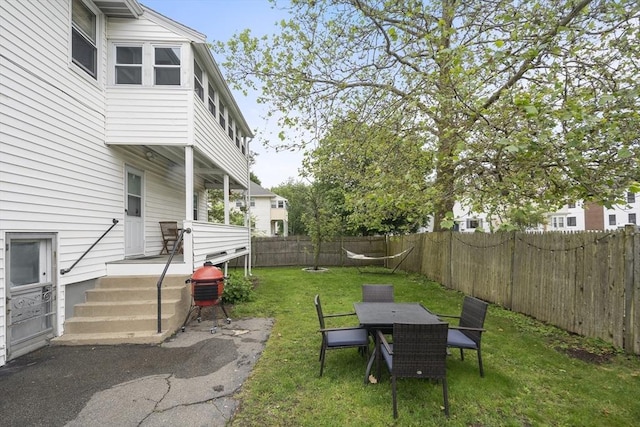 17 Eliot St Unit 17, Medford, MA 02155 - fenced backyard with a wooden deck and outdoor dining area