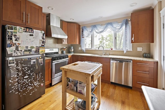 17 Eliot St Unit 17, Medford, MA 02155 - kitchen with appliances with stainless steel finishes, wall chimney range hood, light wood-style flooring, decorative backsplash, and recessed lighting