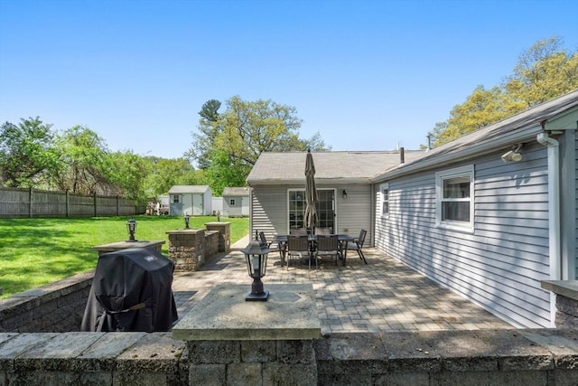 5 Eclipse Ave, Chelmsford, MA 01824 - view of patio featuring a storage unit, outdoor dining space, and an outbuilding