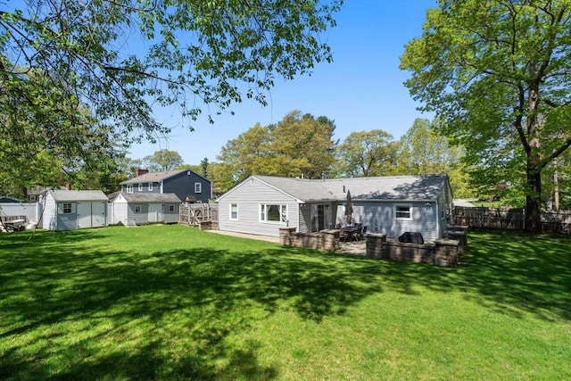 5 Eclipse Ave, Chelmsford, MA 01824 - back of property with a storage unit, an outdoor structure, and a patio area