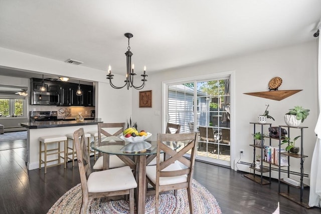 5 Eclipse Ave, Chelmsford, MA 01824 - dining area with a chandelier, plenty of natural light, baseboard heating, and dark wood-type flooring