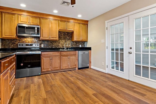 kitchen featuring hardwood / wood-style floors, sink, appliances with stainless steel finishes, and french doors