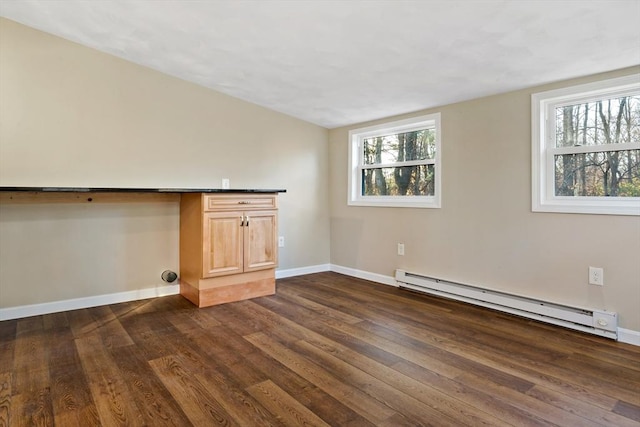 unfurnished room with dark hardwood / wood-style flooring and baseboard heating