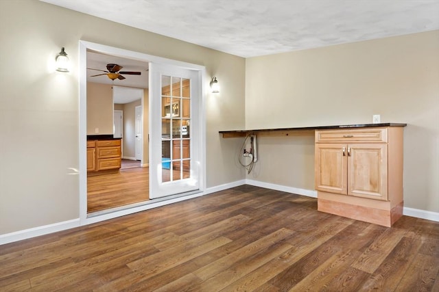 washroom featuring french doors, ceiling fan, and dark wood-type flooring