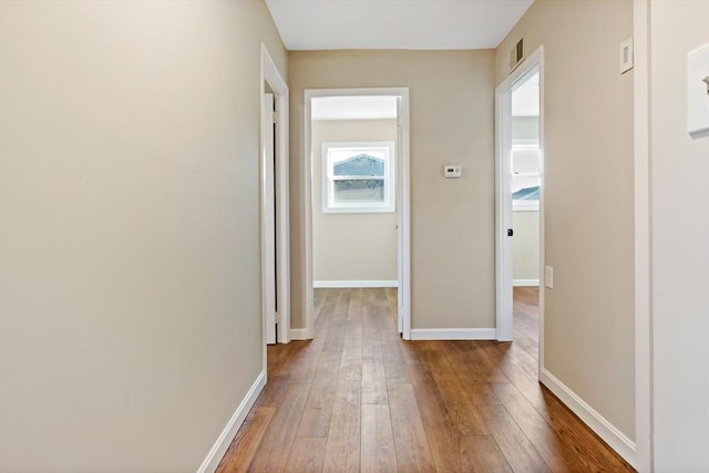 hall with hardwood / wood-style floors