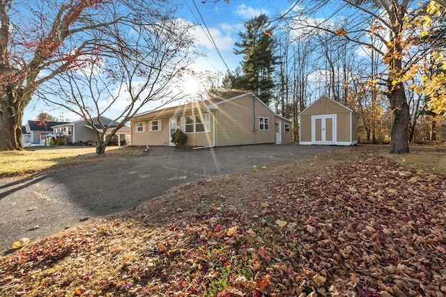 view of property exterior with a storage unit