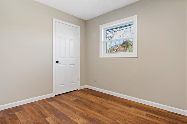 unfurnished room with hardwood / wood-style flooring