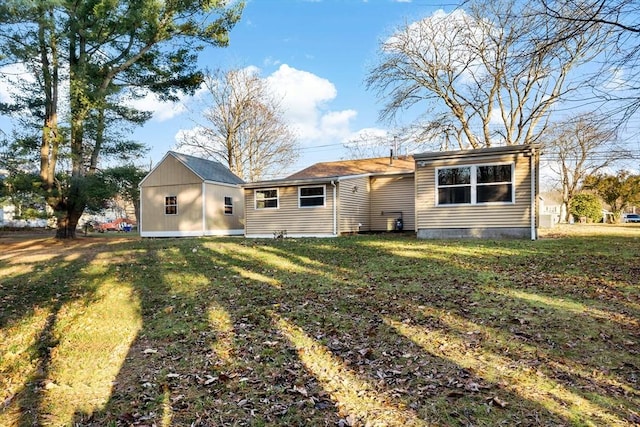 rear view of house with a lawn