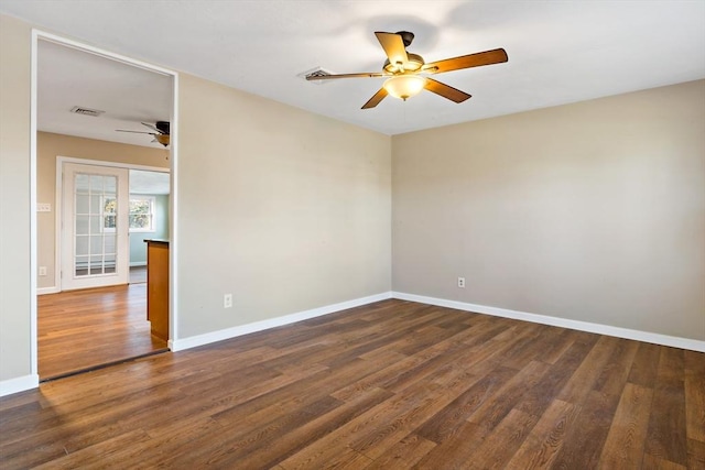 empty room featuring french doors and dark hardwood / wood-style flooring