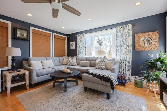 living area with light wood-style floors, a ceiling fan, and recessed lighting