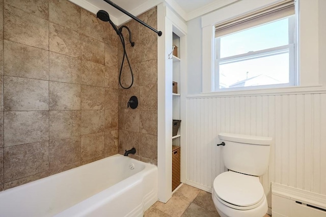 bathroom with toilet, shower / bathtub combination, and wainscoting