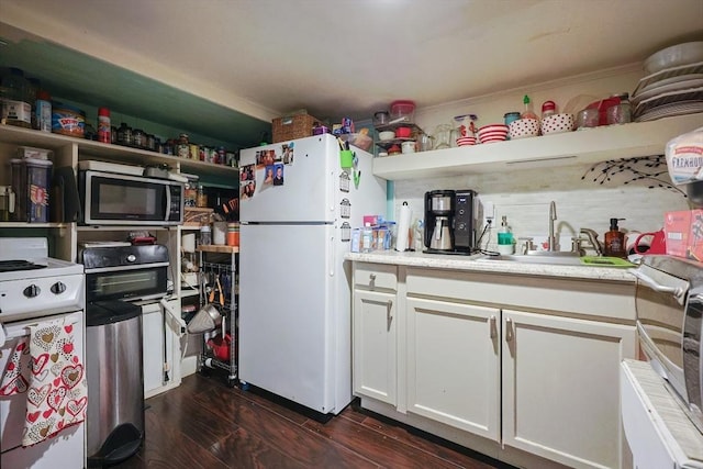 kitchen featuring white appliances, open shelves, and light countertops